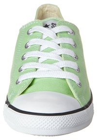 Helle grüne Leinenschuhe mit weißen Schnürsenkeln, gummierter Zehenkappe und strukturiertem Profil. Merkmale sind metallische Ösen und weiße Nähte.
