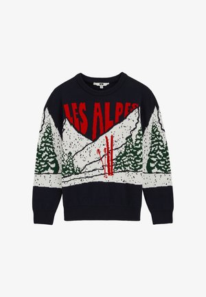 Maglione lavorato a maglia con base blu navy, testo rosso "LES ALPS", montagne bianche e alberi verdi con elementi sciistici rossi. Design classico con collo rotondo.