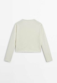 Cropped long-sleeve top in soft cream fabric. Features a round neck and smooth texture, finished with neat seams and no visible hardware.