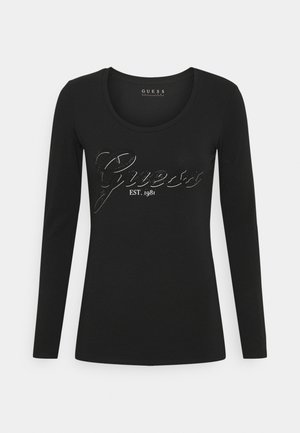 Czarna dopasowana koszula z długim rękawem z logo "Guess EST. 1981" z kryształkami na piersi, okrągłym dekoltem i jednolitym tłem.
