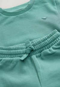 Grön bomullströja och matchande joggers, med ribbad halsringning och elastisk midja, med broderad dinosauriedetalj på tröjan.