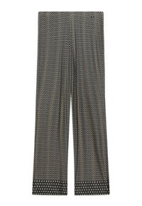 Pantalon noir à jambes larges avec petits motifs géométriques blancs et un ourlet à pois contrastant au bas de chaque jambe.