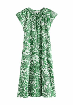 Robe courte à manches courtes, longueur midi, blanche avec imprimé botanique vert, encolure ronde et petit détail de nœud sur le devant.