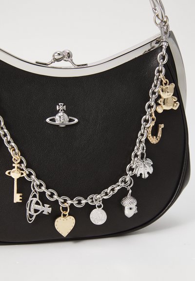 Black handbag with silver frame and chain strap adorned with gold and silver charms including a key, heart, acorn, teddy bear, and horseshoe.