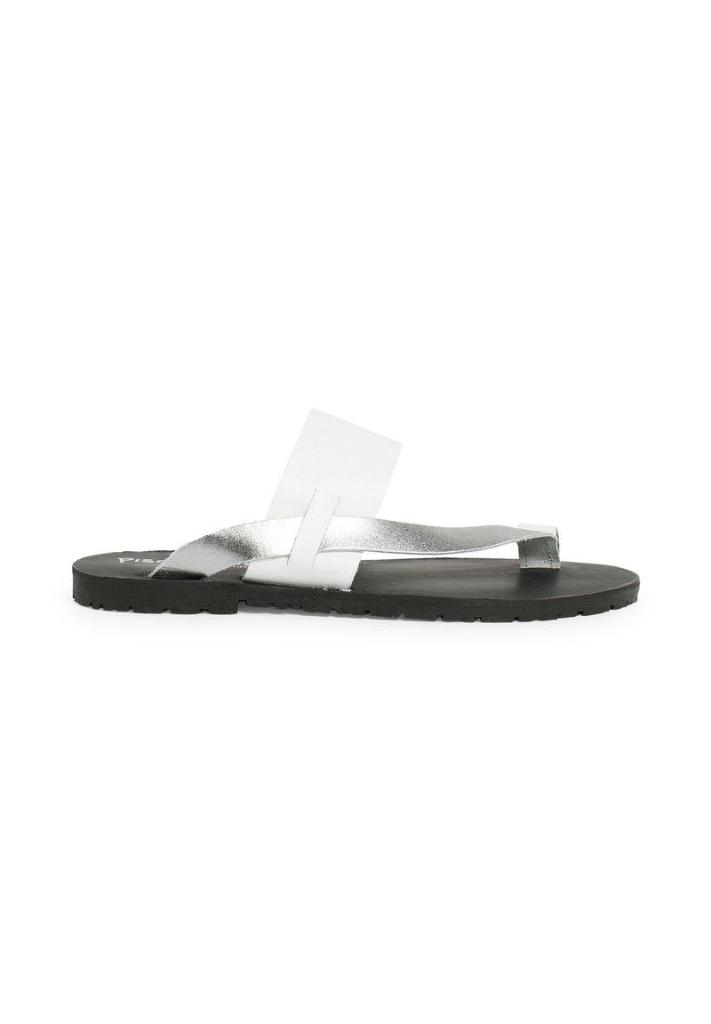 Silver flip-flop sandal with a flat black sole, featuring metallic straps and a transparent accent. Minimalist design and lightweight construction.