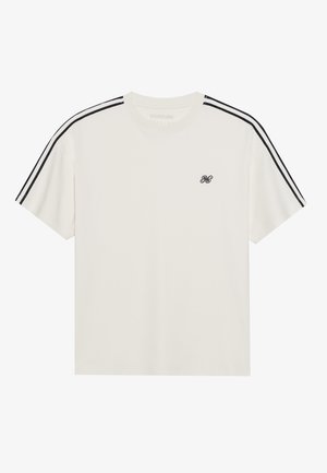 T-shirt à manches courtes, couleur crème, avec des rayures noires sur les épaules, col rond et petit logo noir sur la poitrine. Matière en coton douce.