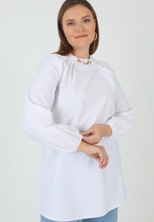 White blouse with long, gathered sleeves and a round neckline. Fabric appears smooth and lightweight, with a relaxed fit.