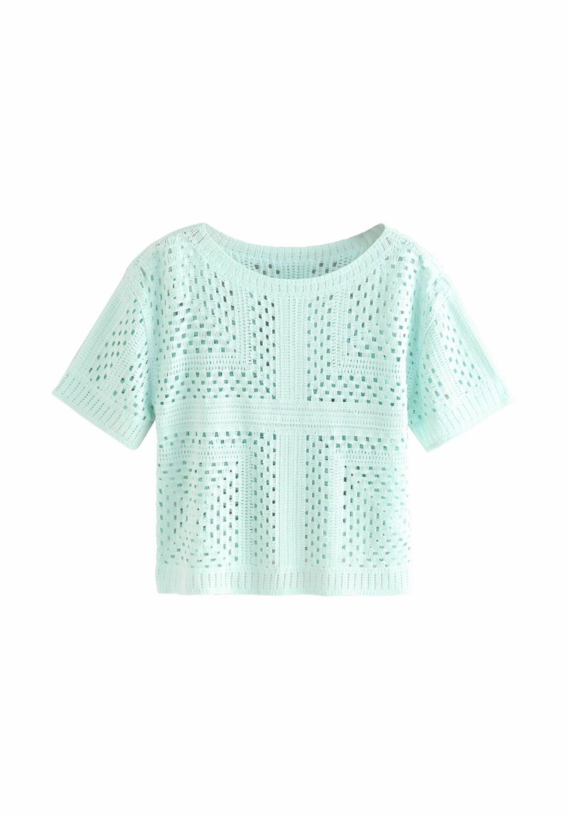 Haut tricoté bleu clair à manches courtes avec un motif ajouré géométrique et un col rond.