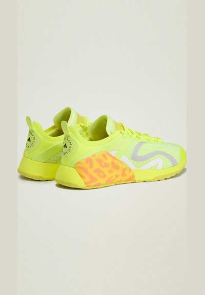 Neon yellow athletic shoes with a lightweight mesh upper, featuring a colorful leopard print accent on the heel and a textured sole.