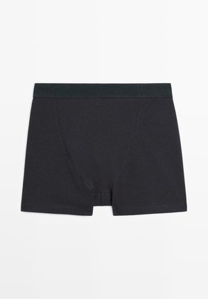 Boxer-briefs en coton noir avec une ceinture sombre unie, des coutures détaillées et une coupe ajustée. Pas de motifs ni de graphiques.