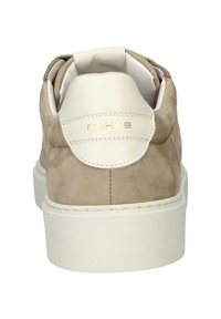 Beige suede sneaker with a white leather accent at the heel. Features subtle stitching and a logo in gold on the back. Flat sole.