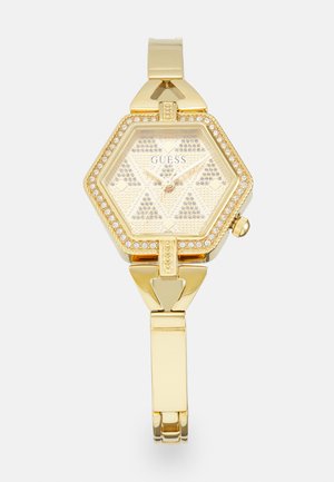 Montre hexagonale dorée avec un cadran texturé et des accents ressemblant à des diamants, dotée d'un bracelet doré assorti et d'un fermoir pour un maintien sécurisé.