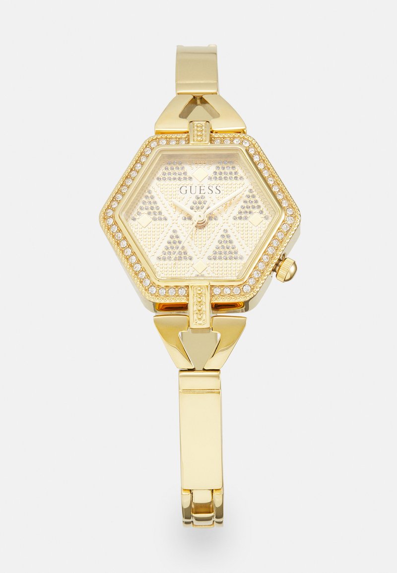 Montre hexagonale dorée avec un cadran texturé et des accents ressemblant à des diamants, dotée d'un bracelet doré assorti et d'un fermoir pour un maintien sécurisé.