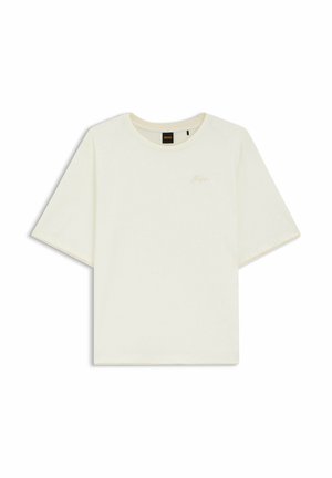 T-shirt à manches courtes en coton crème avec un col rond, présentant un petit détail de logo subtil en rose clair sur la poitrine.