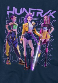Three stylized characters in vibrant outfits: green crop top and patterned pants, yellow jacket with shorts, and black top with yellow skirt, holding a sword.