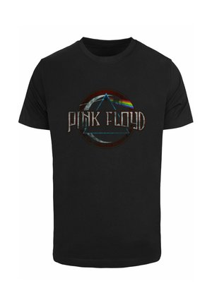 Camiseta de algodón negra con un gráfico circular que presenta un prisma y un arcoíris, y el texto "PINK FLOYD" en letras metálicas.