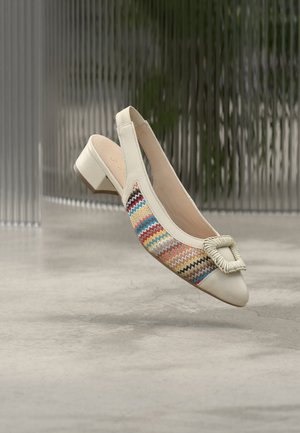 Chaussure plate à bride arrière ivoire avec un petit talon, présentant un motif zigzag coloré sur le côté et une boucle carrée texturée en guise d'accent.