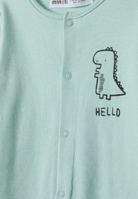 Mint zelena enodelna obleka iz mehkega blaga, z grafiko črnega dinozavra in besedo "HELLO," z naprstnimi zapiranji spredaj.
