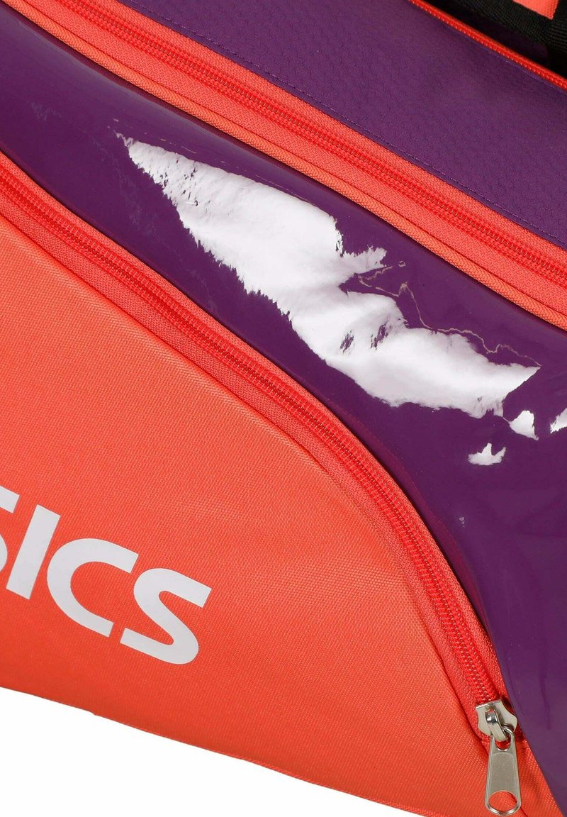 Bright orange and purple sports bag section with red zippers and partially visible white brand lettering.