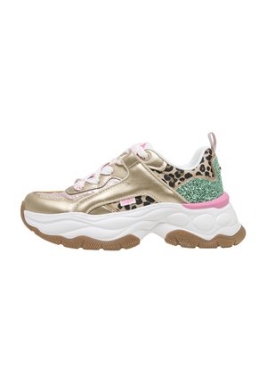 Baskets épaisses avec panneaux métalliques dorés, accents imprimé léopard, talon vert pailleté, détails roses, semelle blanche et bande de roulement marron sur fond blanc.
