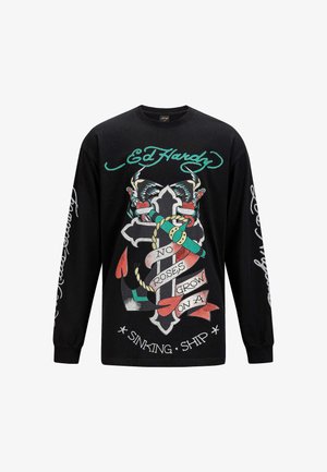 Black long-sleeve shirt featuring bold graphics of a cross, butterflies, and ribbons with text. Printed accents in red, green, and white.