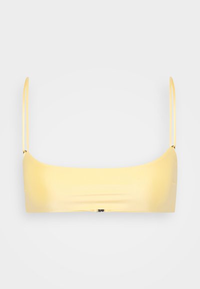 Yellow bandeau bra with thin straps, smooth fabric, minimalistic design, and a seamless construction. No notable hardware or patterns.