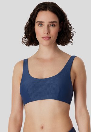 Dunkelblaues Sport-BH mit strukturiertem Design, breiten Trägern und Rundhalsausschnitt, aus einem dehnbaren, atmungsaktiven Material.