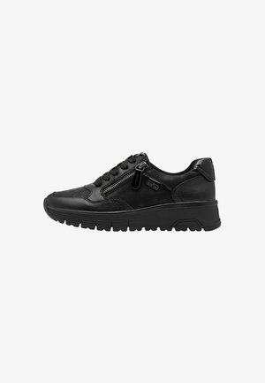 Black sneaker with a textured leather and synthetic upper, zip closure on the side, and a thick rubber sole. Features a rounded toe design.