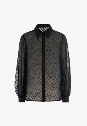 Black sheer blouse with polka dot pattern, button front, and structured collar; features elasticized cuffs and solid black accents.