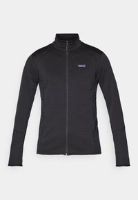 Black zip-up jacket with a high collar, textured fabric, fitted design, and Patagonia logo on the chest pocket. Two side pockets.