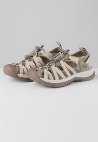 Two-tone sandals with a gray and beige strap design, featuring a thick rubber sole and adjustable closures for secure fit.