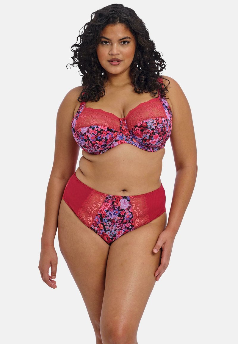 Conjunto de lencería floral que incluye un sujetador con relleno y detalles de encaje rojo, y unas bragas de talle alto. Los colores incluyen púrpura, rosa y rojo con patrones florales.