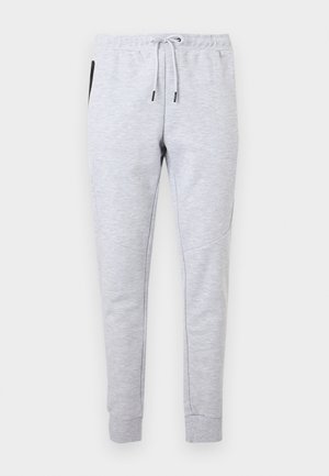 Pantalon de jogging slim gris clair avec taille élastique, cordon blanc, poches latérales et chevilles resserrées.