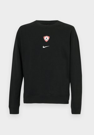 Felpa nera in misto cotone, con uno scudo centrale del logo Jordan in rosso e bianco e un logo Nike bianco sotto. Girocollo e maniche lunghe.