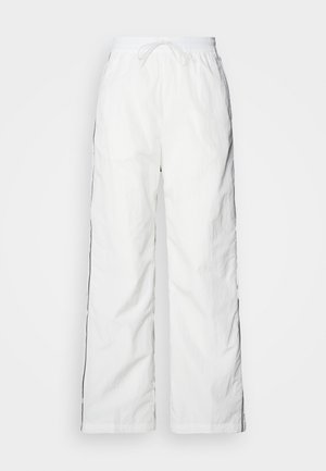 Witte lichtgewicht broek met een relaxte pasvorm, een koordje in de taille en zwarte accenten aan de zijkanten. Gelaagd materiaal met een gekreukt uiterlijk.