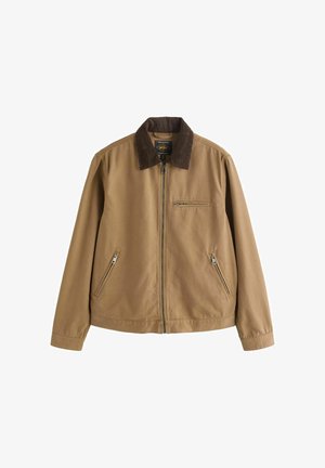 Világosbarna cipzáras dzseki sötétbarna kordbársony gallérral, két oldalsó cipzáras zsebbel és egy cipzáras mellzsebbel, tartós anyagból készült.