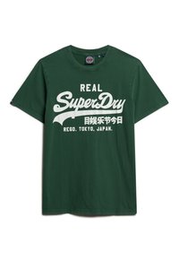 Camiseta de algodón verde con gran texto blanco que dice "REAL SuperDry" con caracteres japoneses y "REGD. TOKYO, JAPAN."