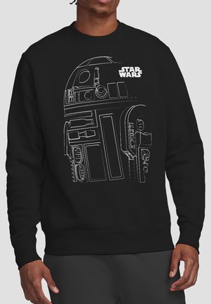 Schwarzer Pullover mit weißer Linienzeichnung des Star Wars-Droiden R2-D2 und dem Star Wars-Logo, getragen von einer Person, die mit entspannten Händen steht.