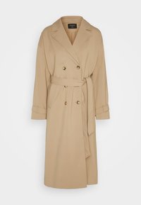 Trench-coat beige croisé avec larges revers, ceinture à la taille, lanières aux poignets et deux poches latérales, longueur genou.