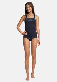 Navy tank top with lace trim along neckline, paired with matching lace-trimmed bottoms. Smooth fabric, fitted design, adjustable straps.