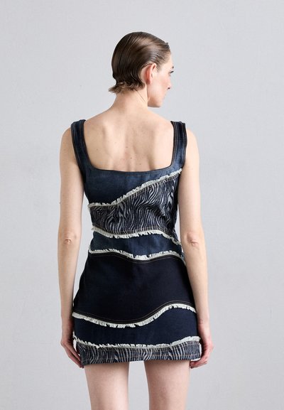 Denim dress with a fitted shape, featuring stitched zebra-patterned accents and frayed edges, in dark blue with a square neckline.