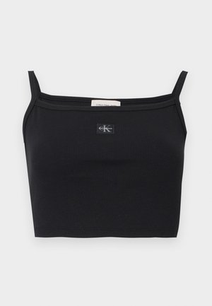 Svart ribbet crop-top med tynne stropper og en liten Calvin Klein-logo midt på brystet.
