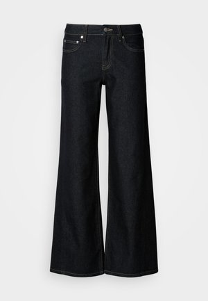 Vidbukse i mørk denim med høy midje, fem lommers design og kontrasterende gule sømmer langs sømmene.