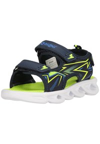 Urheilu sandaalit tummansinisellä ja neonvihreällä designilla, joissa on säädettävät hihnat, teksturoidut pohjat ja valkoinen aaltoileva pohja.