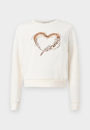 Krémová mikina s kulatým výstřihem, srdcem uprostřed vyrobeným z růžově zlatých flitrů a ribovanými manžetami a spodním lemem.