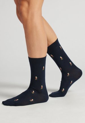 Marine Socken mit bunten Cartoon-Charaktermustern, gerippten Bündchen und einer glatten Textur, mit einem Design in knöchelhöhe.