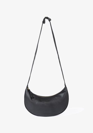 Black crescent-shaped leather shoulder bag with a long adjustable strap and top zipper closure.