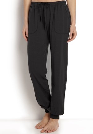Schwarze, lässig geschnittene Hose aus weichem Material mit elastischem Bund und Kordelzug, zwei Seitentaschen und schmal zulaufenden Bündchen.