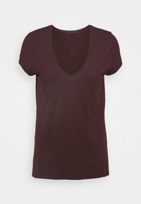 T-paita, jossa on lyhyet hihat, tumma ruskea V-mallinen ja kevyt, hienovaraisella tekstuurilla valkoisella taustalla.