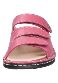 Pink leather sandal featuring three adjustable straps, open toe design, and a textured insole. Black sole with white stitching detail.